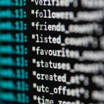 Home Extreme close-up of computer code displaying various programming terms and elements.