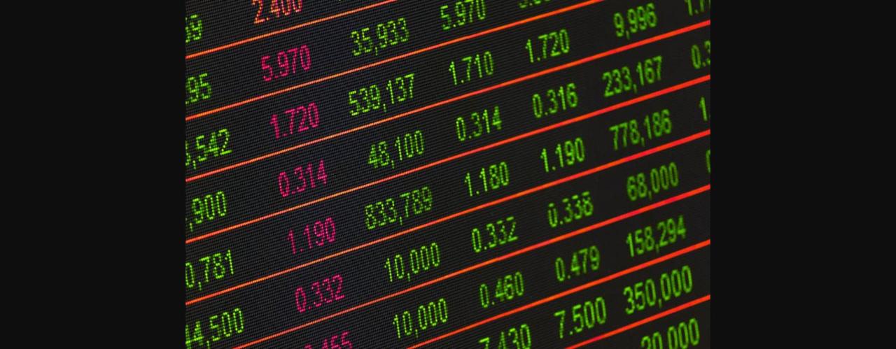 Close-up of a digital stock market data display showing colorful financial numbers and trends.